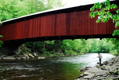 Angler fishing under the Joshia Hess Covered Bridge. Huntington Creek, PA Angler fishing under the Joshia Hess Covered Bridge. Huntington Creek, PA